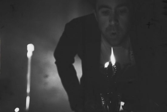 Justin Young blowing out a candle